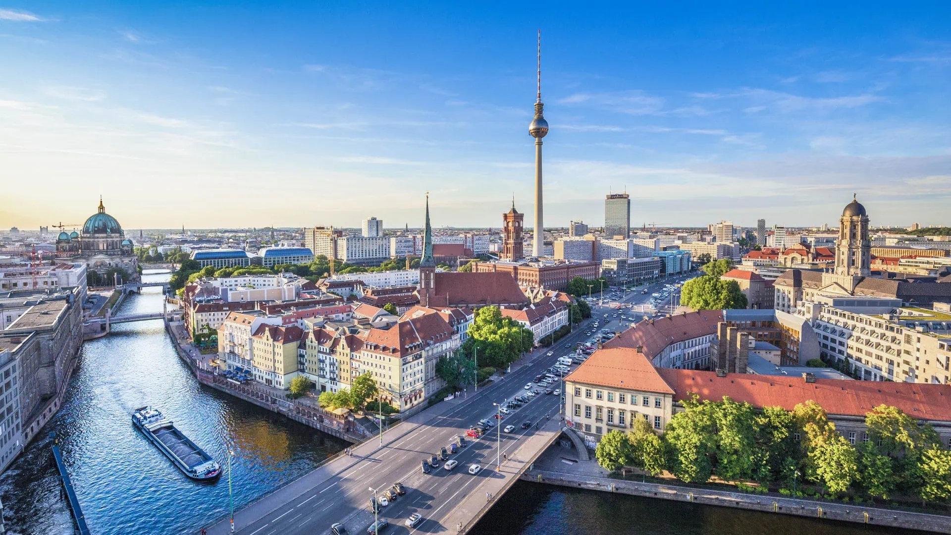 Berlin skyline panorama with TV tower and Spree river at sunset,